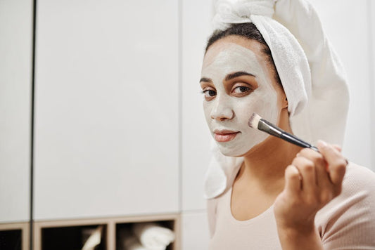 Woman performing at-home facial with LED light therapy device